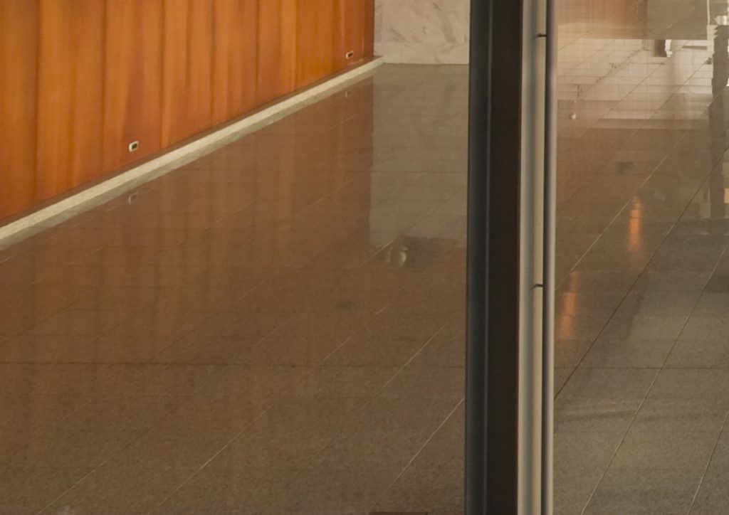 Polished lobby floor against a timber wall