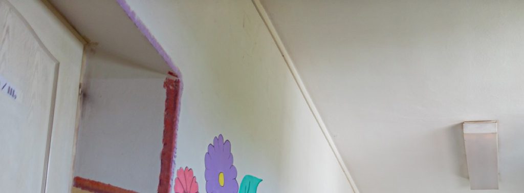 School corridor wall with children's drawings