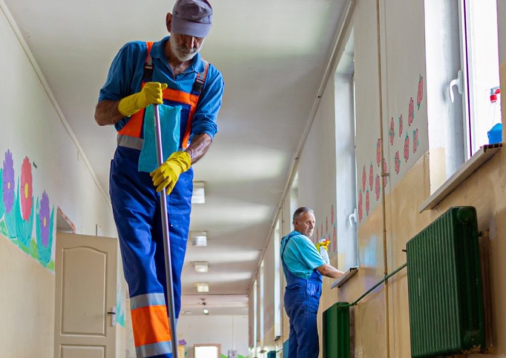 Cleaners working in a school corridor