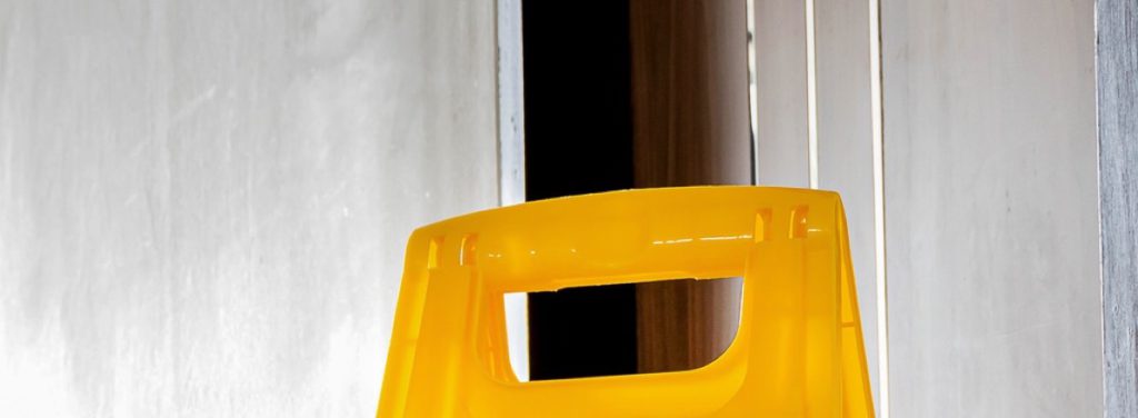 Handle of a yellow mop wringer