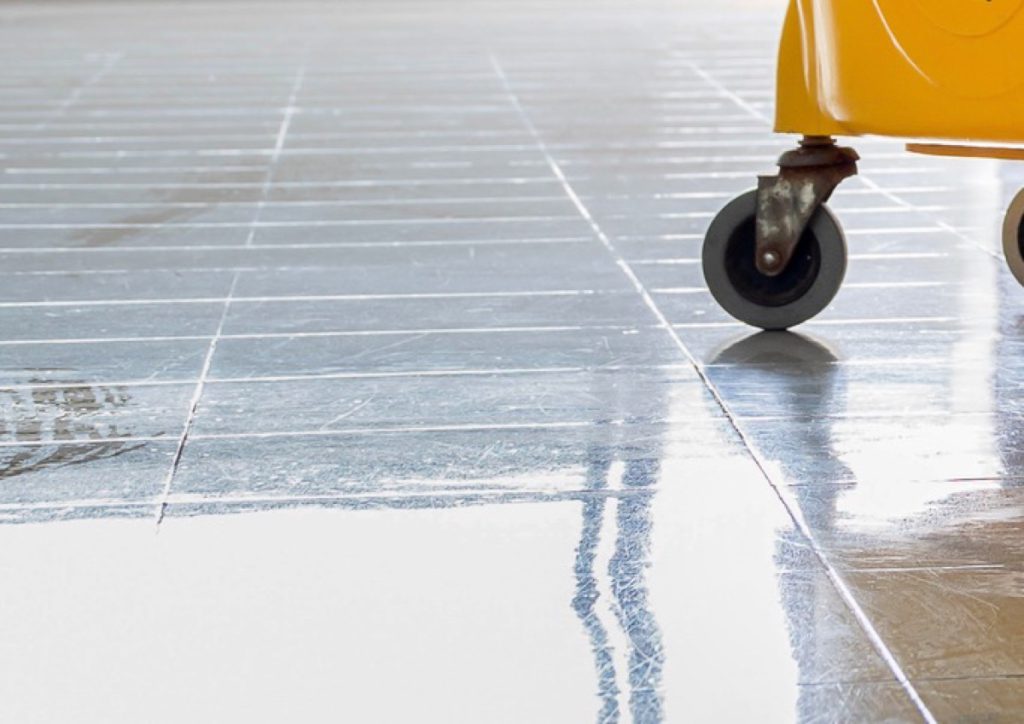 Wet tiled floor with a trolley wheel